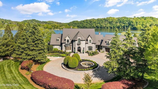 aerial view featuring a water view and a wooded view