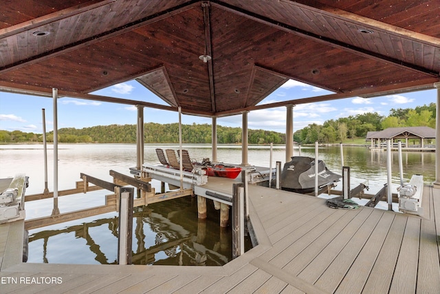 view of dock with boat lift and a water view
