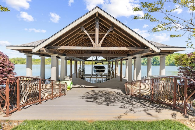 dock area with boat lift and a water view