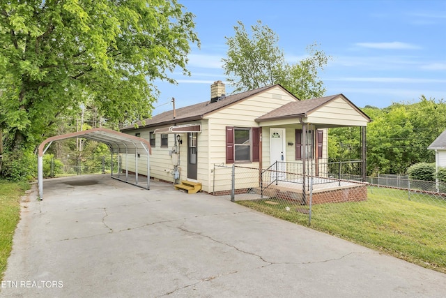 bungalow-style house with fence, a front yard, a chimney, concrete driveway, and a detached carport