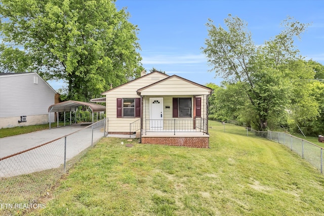 bungalow-style house with fence private yard, a detached carport, a front lawn, concrete driveway, and a porch