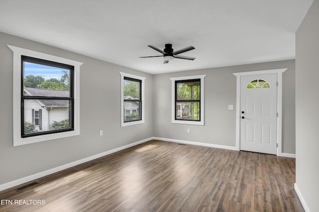 entryway featuring a ceiling fan, baseboards, visible vents, and wood finished floors