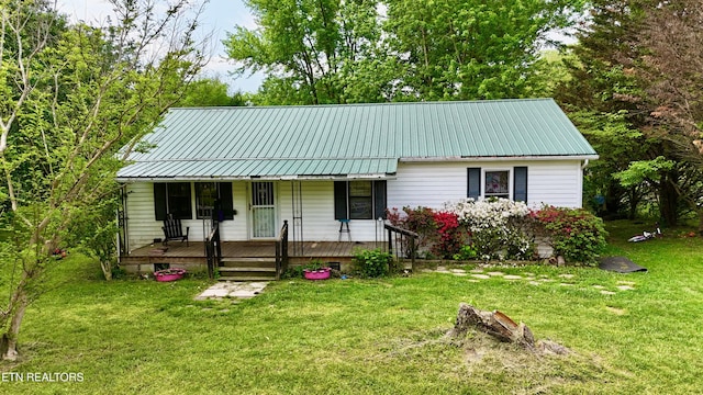 129 George Howard Rd, Sunbright, TN 37872 - view of front of property featuring a porch, metal roof, and a front lawn