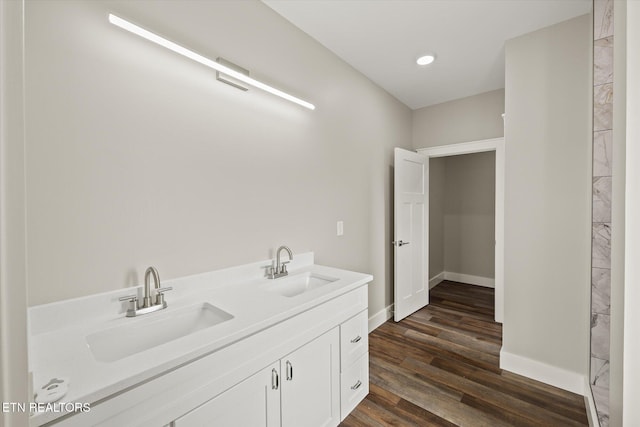 448 Taylor Rd, Byrdstown, TN 38549 - bathroom featuring double vanity, baseboards, a sink, and wood finished floors