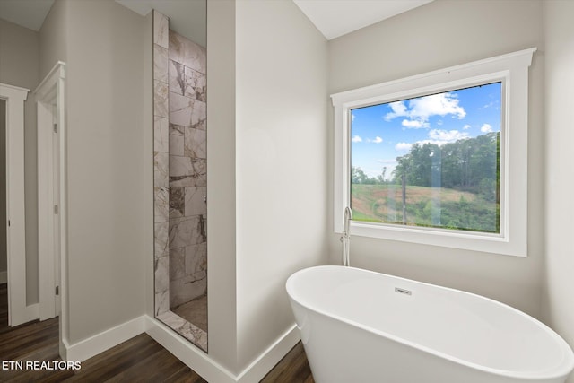 448 Taylor Rd, Byrdstown, TN 38549 - bathroom featuring baseboards, a freestanding tub, wood finished floors, and a tile shower
