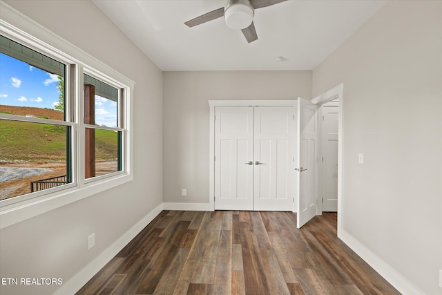 448 Taylor Rd, Byrdstown, TN 38549 - unfurnished bedroom featuring a ceiling fan, dark wood-style flooring, visible vents, baseboards, and a closet