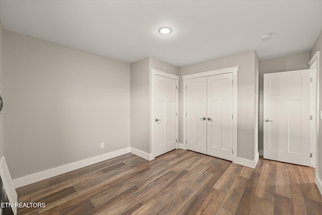 448 Taylor Rd, Byrdstown, TN 38549 - unfurnished bedroom with recessed lighting, baseboards, dark wood finished floors, and a closet