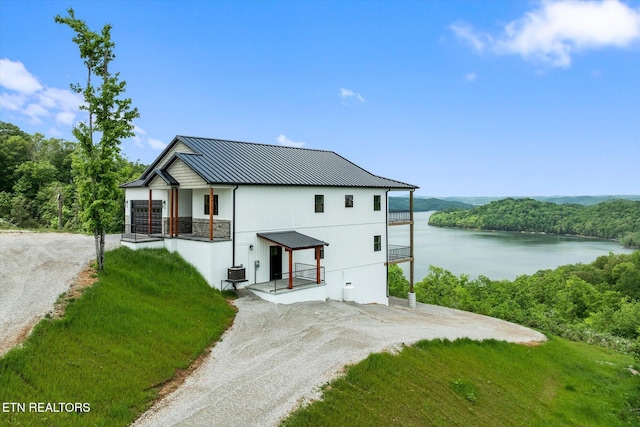 448 Taylor Rd, Byrdstown, TN 38549 - back of property featuring a standing seam roof, dirt driveway, metal roof, a water view, and central air condition unit