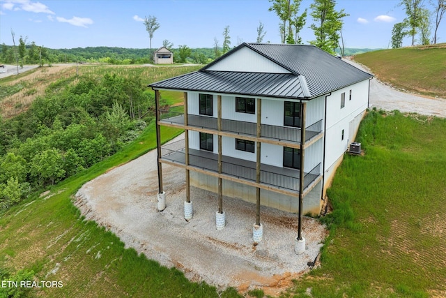 448 Taylor Rd, Byrdstown, TN 38549 - rear view of property with central AC unit, a balcony, a standing seam roof, a yard, and metal roof