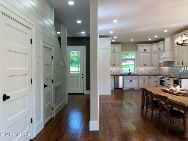 interior space featuring dark countertops, dark wood-style floors, a sink, and tasteful backsplash