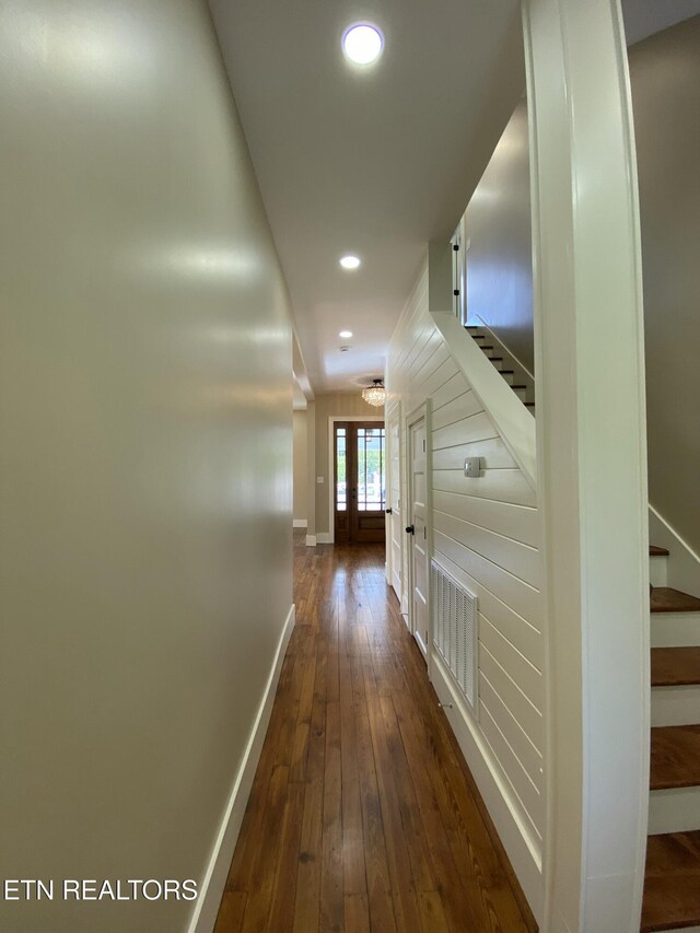 hall featuring baseboards, recessed lighting, stairs, and dark wood-type flooring