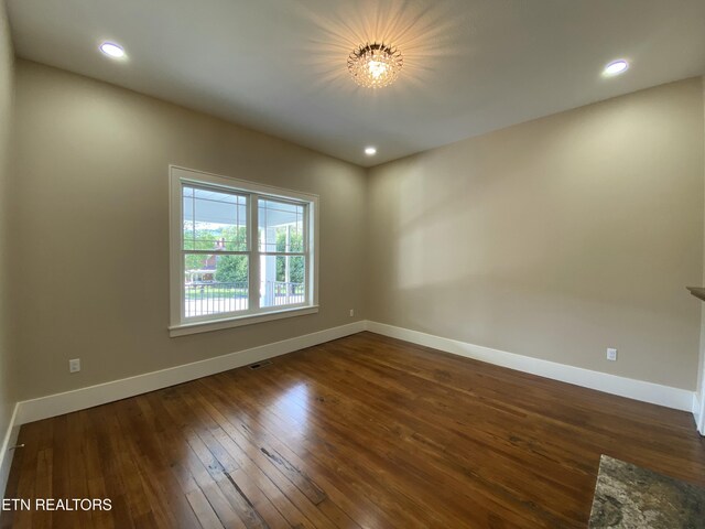 unfurnished room with recessed lighting, baseboards, and dark wood-style floors