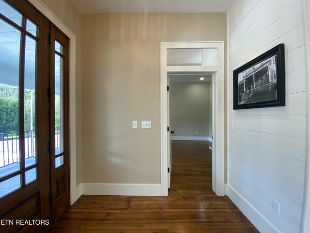 foyer with baseboards and dark wood-style floors