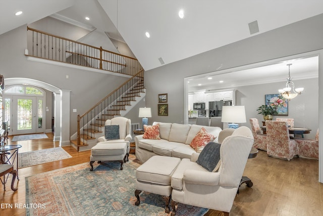 1614 Pinnacle Point Dr, Alcoa, TN 37701 - living room featuring stairs, high vaulted ceiling, recessed lighting, arched walkways, and light wood finished floors
