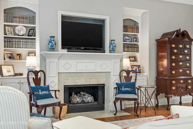 1614 Pinnacle Point Dr, Alcoa, TN 37701 - living area featuring built in features, a tiled fireplace, and wood finished floors