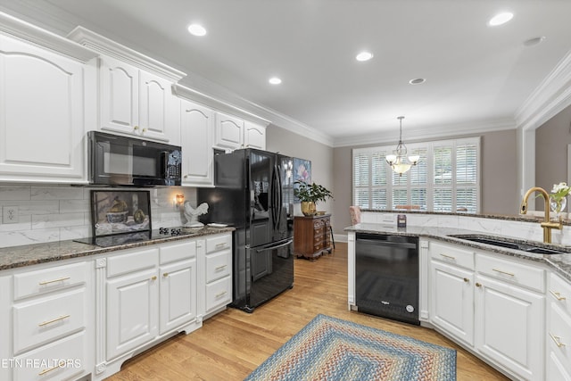 1614 Pinnacle Point Dr, Alcoa, TN 37701 - kitchen with crown molding, white cabinets, a notable chandelier, a sink, and black appliances