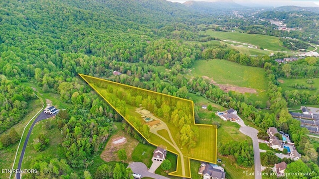 drone / aerial view with a wooded view
