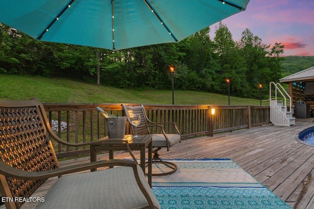 deck at dusk with a lawn