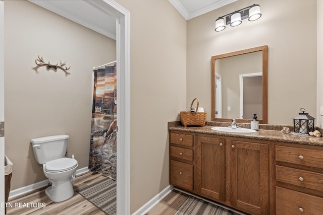 full bath with crown molding, vanity, toilet, baseboards, and wood finished floors