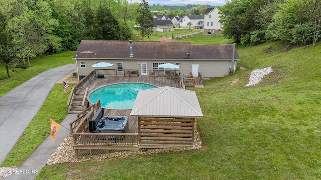 view of pool with a lawn, stairway, and a deck