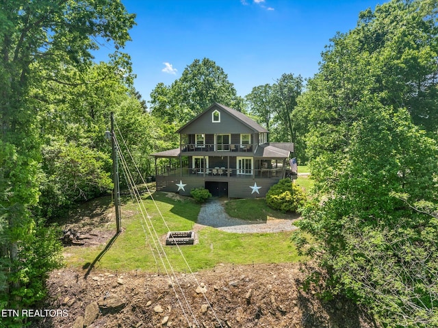 back of property with a yard and a balcony