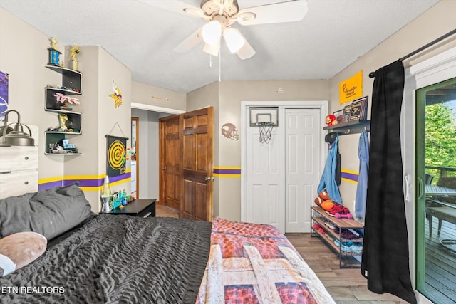 bedroom with a closet, a ceiling fan, and wood finished floors