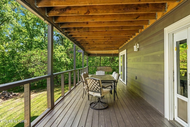 wooden terrace with outdoor dining area