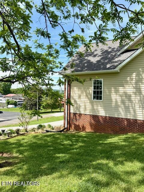 217 Loomis St, Tellico Plains, TN 37385 - view of side of property with a lawn and a shingled roof