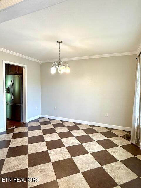 217 Loomis St, Tellico Plains, TN 37385 - unfurnished dining area with an inviting chandelier, baseboards, and ornamental molding