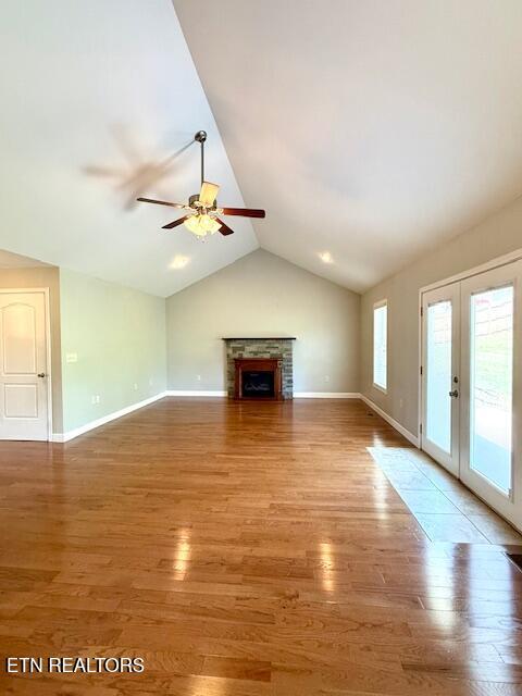 217 Loomis St, Tellico Plains, TN 37385 - unfurnished living room featuring french doors, a ceiling fan, baseboards, light wood-type flooring, and vaulted ceiling