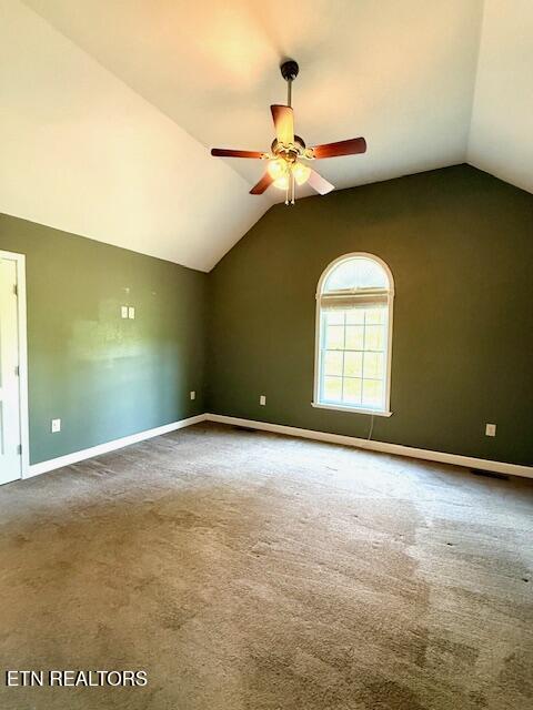 217 Loomis St, Tellico Plains, TN 37385 - unfurnished room featuring baseboards, a ceiling fan, vaulted ceiling, and carpet floors