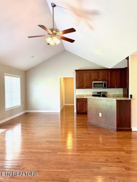 217 Loomis St, Tellico Plains, TN 37385 - kitchen with ceiling fan, appliances with stainless steel finishes, baseboards, open floor plan, and light wood-style floors