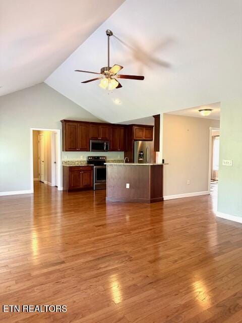 217 Loomis St, Tellico Plains, TN 37385 - unfurnished living room with baseboards, ceiling fan, high vaulted ceiling, and wood finished floors