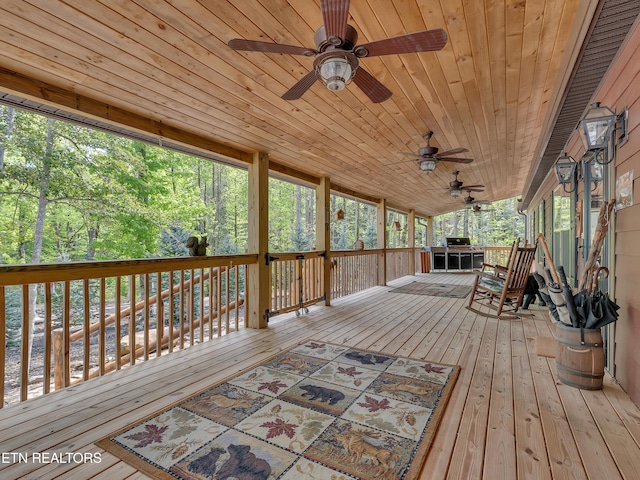 wooden deck featuring a water view and ceiling fan