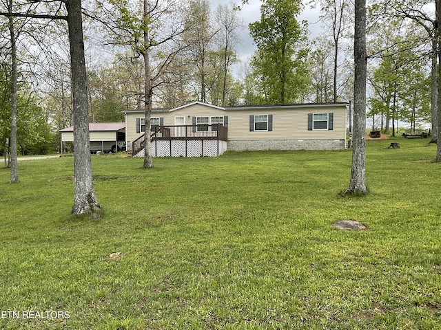 view of front facade with a front yard and a deck