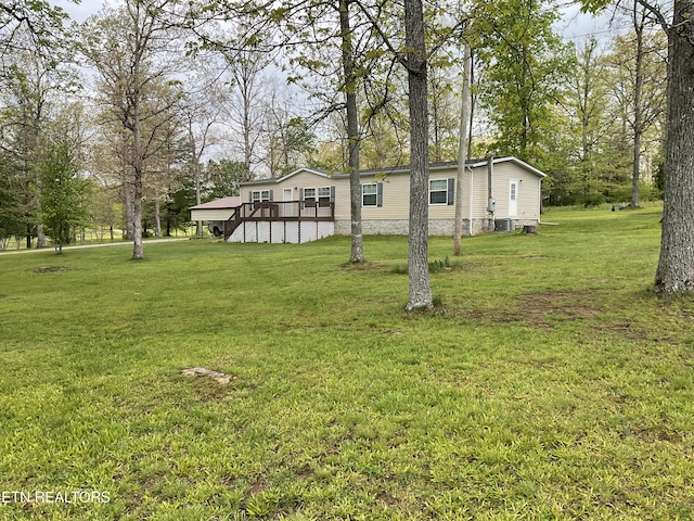 view of yard featuring a deck and central AC