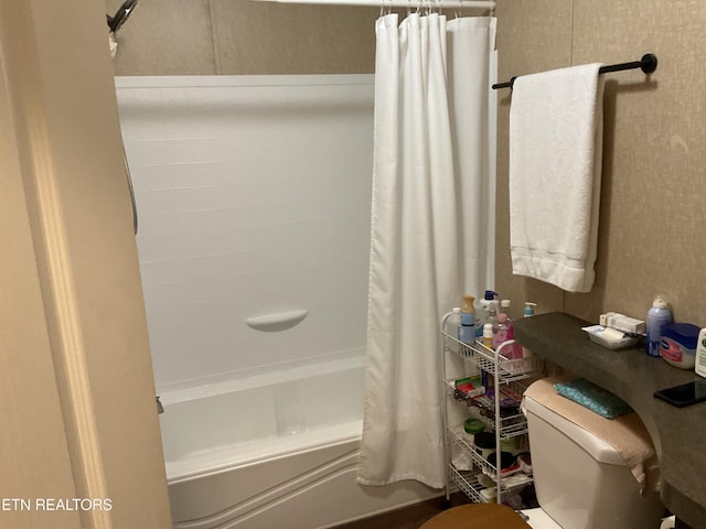 bathroom with shower / tub combo and toilet
