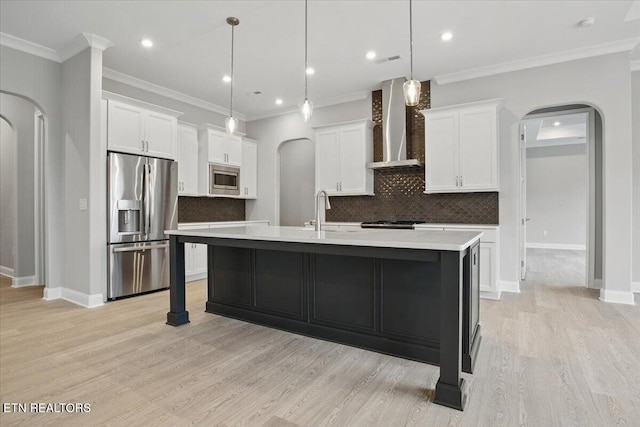 342 Bittersweet Ln, Lenoir City, TN 37771 - kitchen with stainless steel appliances, wall chimney range hood, arched walkways, a sink, and recessed lighting