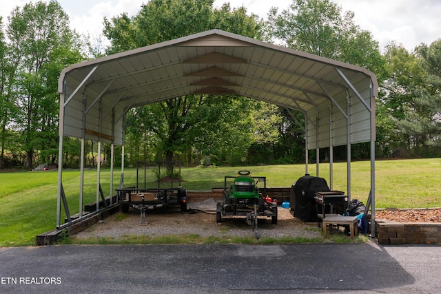 view of car parking with a detached carport and driveway