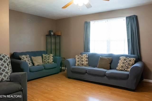 living area featuring ceiling fan and wood finished floors
