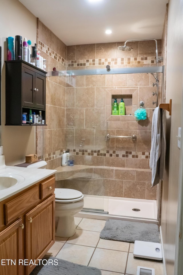 bathroom featuring vanity, tile patterned flooring, a shower stall, and toilet