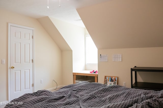 bedroom with lofted ceiling
