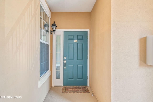 view of exterior entry with stucco siding