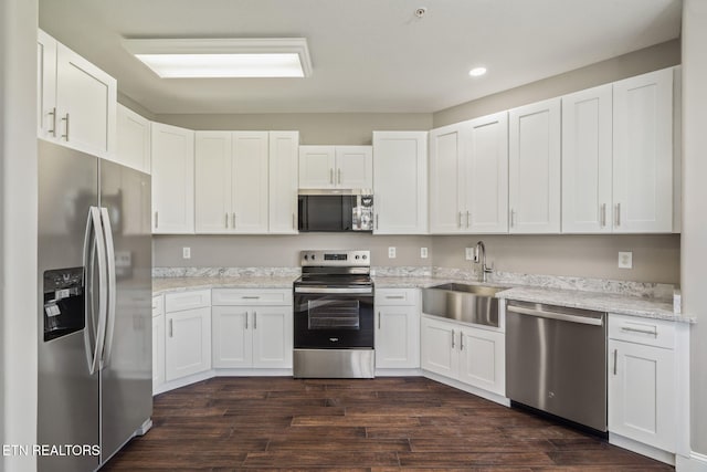 kitchen featuring white cabinetry, appliances with stainless steel finishes, a sink, and recessed lighting