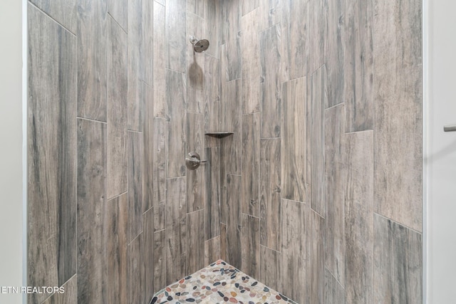 interior space featuring a tile shower
