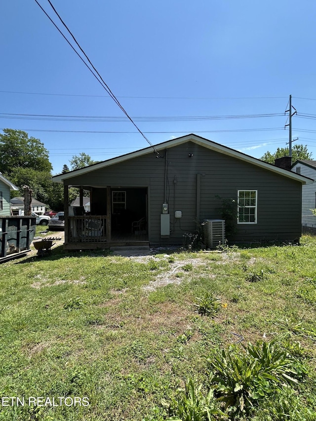 exterior space featuring a lawn and cooling unit