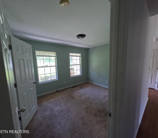 2094 NW Cecil Johnson Rd, Knoxville, TN 37921 - unfurnished room featuring baseboards, a smoke detector, and dark carpet