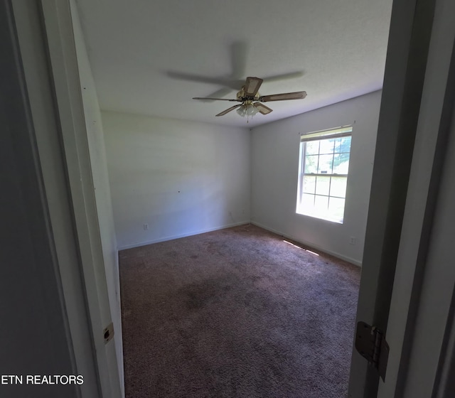 2094 NW Cecil Johnson Rd, Knoxville, TN 37921 - spare room with carpet flooring, a ceiling fan, and baseboards