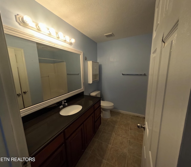 2094 NW Cecil Johnson Rd, Knoxville, TN 37921 - bathroom featuring vanity, toilet, a textured ceiling, tile patterned floors, and baseboards