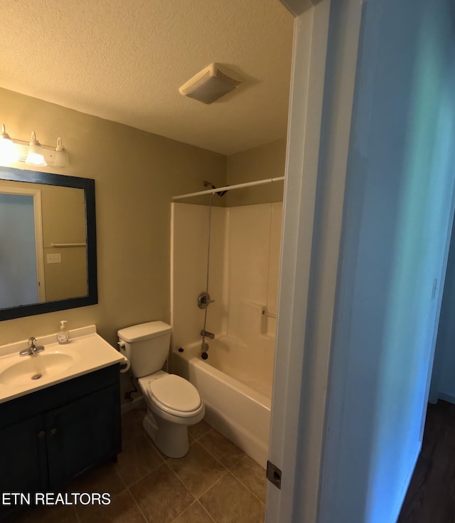 2094 NW Cecil Johnson Rd, Knoxville, TN 37921 - bathroom featuring vanity, toilet, a textured ceiling, shower / washtub combination, and tile patterned flooring